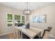 Bright dining room with large windows, modern light fixture, and neutral decor for elegant meals at 3211 Gilroy Dr, Fort Mill, SC 29707