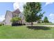 Charming two-story home features a three-car garage, manicured lawn, and inviting curb appeal at 3211 Gilroy Dr, Fort Mill, SC 29707