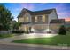 Charming two-story home features a three-car garage, manicured lawn, and inviting curb appeal at 3211 Gilroy Dr, Fort Mill, SC 29707