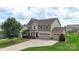 Charming two-story home features a three-car garage, manicured lawn, and inviting curb appeal at 3211 Gilroy Dr, Fort Mill, SC 29707