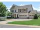 Charming two-story home features a three-car garage, manicured lawn, and inviting curb appeal at 3211 Gilroy Dr, Fort Mill, SC 29707