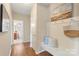 Hallway with bench seating and decor leading to a bathroom with tile flooring at 3211 Gilroy Dr, Fort Mill, SC 29707