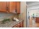 Kitchen counter featuring granite countertops, stainless steel fridge and view into dining room at 3211 Gilroy Dr, Fort Mill, SC 29707