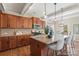 An open kitchen features granite countertops, wood cabinets, and a kitchen island with bar stool seating at 3211 Gilroy Dr, Fort Mill, SC 29707
