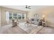 Cozy living room with plush carpeting, a ceiling fan, and lots of natural light at 3211 Gilroy Dr, Fort Mill, SC 29707