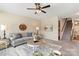 Comfortable living room with plush carpeting, ceiling fan, and view of the staircase at 3211 Gilroy Dr, Fort Mill, SC 29707