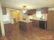 Functional kitchen with island, stainless steel appliances, and wood-look flooring at 3942 Benny Shrum Ln, Maiden, NC 28650