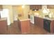 Functional kitchen with island, stainless steel appliances, and wood-look flooring at 3942 Benny Shrum Ln, Maiden, NC 28650