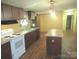 Functional kitchen with island, stainless steel appliances, and wood-look flooring at 3942 Benny Shrum Ln, Maiden, NC 28650