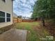Large, level backyard featuring a privacy fence, trees and a patio, perfect for outdoor entertaining at 4009 Egrets Nest Ct, Mount Holly, NC 28120