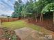 Spacious backyard with a concrete patio, a privacy fence, and mature trees creating a private oasis at 4009 Egrets Nest Ct, Mount Holly, NC 28120