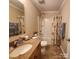 Bathroom with a granite vanity, shower/tub combination, a decorative mirror and tile flooring at 4009 Egrets Nest Ct, Mount Holly, NC 28120