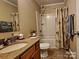 Well-lit bathroom with a granite vanity, shower/tub combination, and tile flooring at 4009 Egrets Nest Ct, Mount Holly, NC 28120