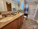 Bathroom featuring a double vanity with granite countertop, shower/tub, and tile flooring at 4009 Egrets Nest Ct, Mount Holly, NC 28120