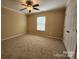 Cozy bedroom with carpet flooring, a ceiling fan, and a window offering natural light at 4009 Egrets Nest Ct, Mount Holly, NC 28120