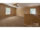 Bonus room with a ceiling fan, neutral carpet, and multiple windows for natural light at 4009 Egrets Nest Ct, Mount Holly, NC 28120