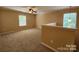 Spacious bonus room with neutral carpet and natural light from two windows at 4009 Egrets Nest Ct, Mount Holly, NC 28120