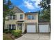 Charming two-story home featuring a two-car garage, well-maintained lawn, and inviting front entrance at 4009 Egrets Nest Ct, Mount Holly, NC 28120