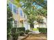 Two-story home with a well-manicured lawn and a two-car garage, surrounded by mature trees at 4009 Egrets Nest Ct, Mount Holly, NC 28120