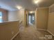 Upstairs hallway with neutral paint and carpet and an abundance of natural light at 4009 Egrets Nest Ct, Mount Holly, NC 28120