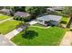Aerial view showcases a landscaped lawn, a paved driveway, and mature trees surrounding the property at 4042 Uppergate Ln, Charlotte, NC 28215