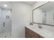 Bathroom featuring walk-in shower, marble countertop and brown cabinets at 4042 Uppergate Ln, Charlotte, NC 28215