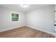Bedroom with a window, grey walls, and light wood floors at 4042 Uppergate Ln, Charlotte, NC 28215