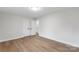 Bedroom with a closet, grey walls, and light wood floors at 4042 Uppergate Ln, Charlotte, NC 28215