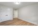 Bedroom with a closet, grey walls, and light wood floors at 4042 Uppergate Ln, Charlotte, NC 28215