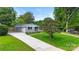 A charming house with a long driveway and a manicured lawn, enhanced by mature trees at 4042 Uppergate Ln, Charlotte, NC 28215