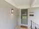 A close-up of the front entrance, featuring a stylish door, modern lighting, and clear numbering at 4042 Uppergate Ln, Charlotte, NC 28215