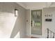 Close-up of the home's stylish front door, showcasing the freshly painted brick and modern lighting fixture at 4042 Uppergate Ln, Charlotte, NC 28215