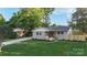 Lovely single-story home with lush green lawn, freshly painted exterior, and newly installed fence at 4042 Uppergate Ln, Charlotte, NC 28215