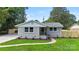 Single-story home showcasing newly planted landscaping, a walkway to the front door, and manicured lawn at 4042 Uppergate Ln, Charlotte, NC 28215