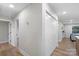 Hallway with a closet, grey walls, and light wood floors at 4042 Uppergate Ln, Charlotte, NC 28215