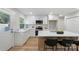 Contemporary kitchen with white cabinets, a stainless steel range, and a center island with seating at 4042 Uppergate Ln, Charlotte, NC 28215
