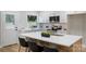 Modern kitchen with white cabinets, stainless steel appliances and a large island with seating at 4042 Uppergate Ln, Charlotte, NC 28215