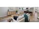 Cozy living room with modern decor, light wood floors, view of kitchen, and natural light at 4042 Uppergate Ln, Charlotte, NC 28215
