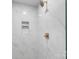 Shower featuring marble tile, bronze hardware, and built-in shelving at 4042 Uppergate Ln, Charlotte, NC 28215