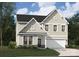 Charming two-story home featuring stone accents, neutral siding, and attached two-car garage at 4114 Vista Pine Dr, Charlotte, NC 28215