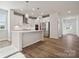 Well-lit kitchen with modern appliances, white cabinets, hardwood floors, and island with sink at 4114 Vista Pine Dr, Charlotte, NC 28215