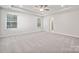 Spacious primary bedroom with neutral carpet, recessed lighting, and dual windows at 4114 Vista Pine Dr, Charlotte, NC 28215