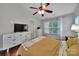 Bedroom featuring hardwood floors, vaulted ceiling, and white dresser with tv on top at 413 Hurston Cir, Charlotte, NC 28208