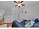 Cozy bedroom showcases a ceiling fan, light walls and a bed with decorative pillows and comforter at 413 Hurston Cir, Charlotte, NC 28208