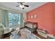 Bright Bedroom featuring a wooden crib, colorful rug, and natural light from a large window at 413 Hurston Cir, Charlotte, NC 28208