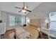 Comfortable bedroom with a large window, hardwood floors, and a decorative ceiling fan at 413 Hurston Cir, Charlotte, NC 28208