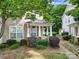 Charming home with an American flag, manicured landscaping, and a welcoming front porch and traditional design at 413 Hurston Cir, Charlotte, NC 28208