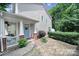 Charming home with a cozy covered front porch, fresh landscaping, and a delightful blue door at 413 Hurston Cir, Charlotte, NC 28208