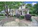 Inviting townhome showcasing charming curb appeal with lush landscaping and an American flag at 413 Hurston Cir, Charlotte, NC 28208