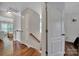 Upstairs hallway with wood floors leading to bedrooms at 413 Hurston Cir, Charlotte, NC 28208